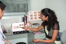 Renuka Foneska making notes as she tests a client's hearing