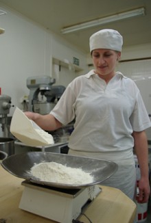 Stacey Johnson pours flour onto scales