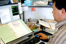 A clinical coder looking at a computer screen.