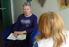 Sally Latham talking to a client in an office