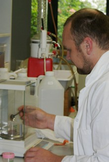 A forestry scientist working with samples in a laboratory.
