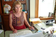 Tessa Jones sitting at her desk typing on the computer