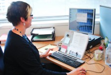 Laura Feasey writing a document at her computer.