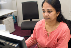 Lakshmi Murali sitting at a computer