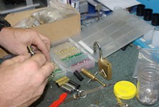 Close-up of a locksmith working with a padlock