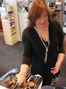Natalie Young picking up a make-up brush
