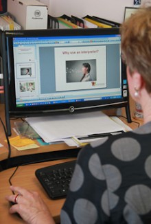 Robyn Pask sitting at a computer preparing a presentation