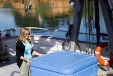 Candida Savage standing by a big container on a boat