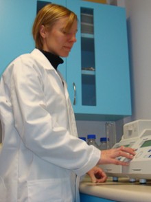 Tina Summerfield pressing buttons on a piece of laboratory equipment