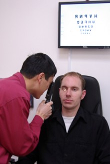 Selywn Yan inspects a customer's eye.