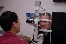 Selwyn Yan tests a customer's eyes.