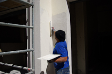 An exterior plaster applying plaster to a wall