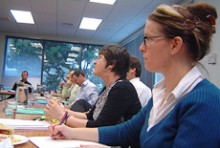 Melissa Jessen sitting in a meeting room alongside colleagues