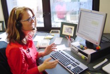 Melissa Jessen talking on the phone at her computer