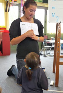 Mahina Law showing the alphabet to children