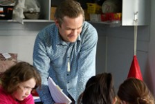 David Pierson working alongside children in a classroom