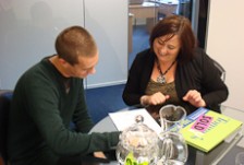 Tracy Logan and a client sitting at a table, looking at papers