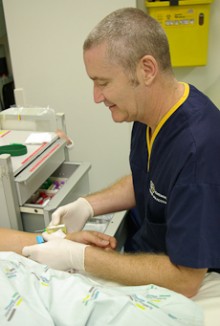 Michael Geraghty giving a patient an injection