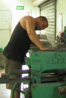 A saw doctor inspecting a large industrial saw