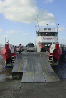 A vehicle ferry with its gangplank down, ready for cars to drive off