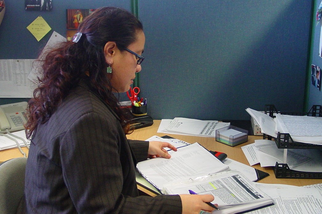 Janine Olasa and a colleague looking at a report