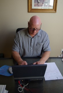 Greg Stewart using his computer to prepare a legal document