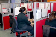 Rochelle Tapuai sitting in a booth in front of a computer wearing a headset