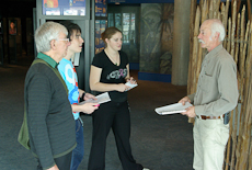 Tony Kuepfer, right, standing talking to a group of museum tour guide trainees, in Te Papa museum