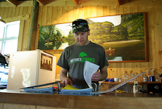 Zane Smith looking through a bookings folder in his office