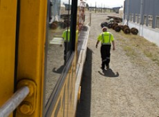 Jim Featherstone walking along a track beside a locomotive