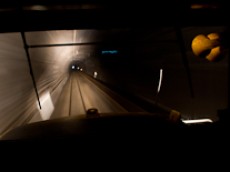 A photo out of the front window of a train as it passes through a tunnel