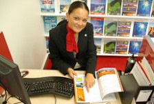 Jessica Strawbridge points to a destination in a travel brochure