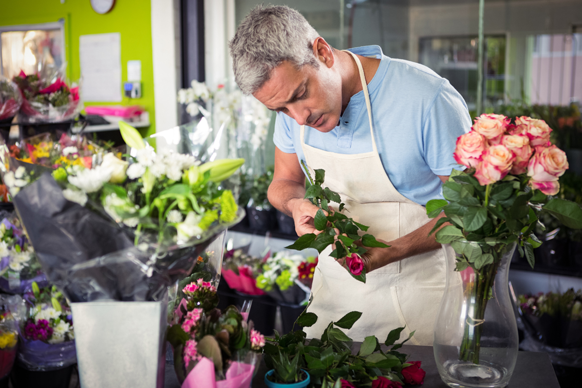 Male florist trimming roses