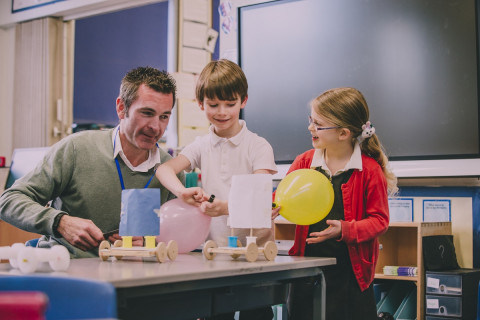 Male teacher with two young students