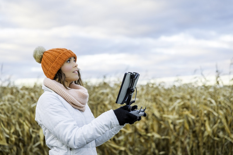 A drone pilot working in a field