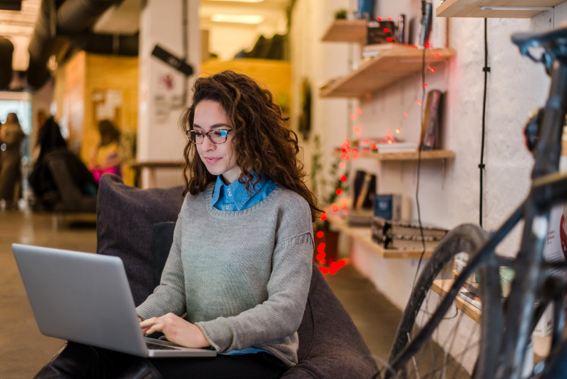 A young woman studying on her laptop