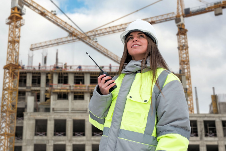 Engineer stands in front of construction site