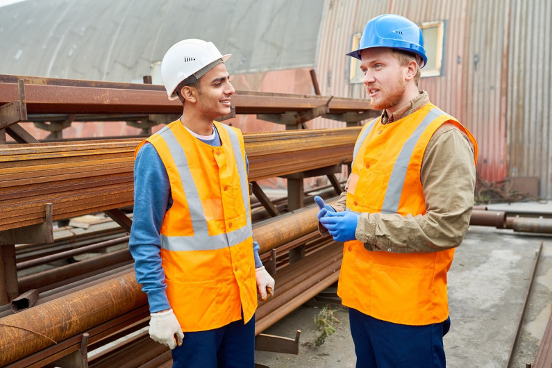 Two engineers talking in a railway yard