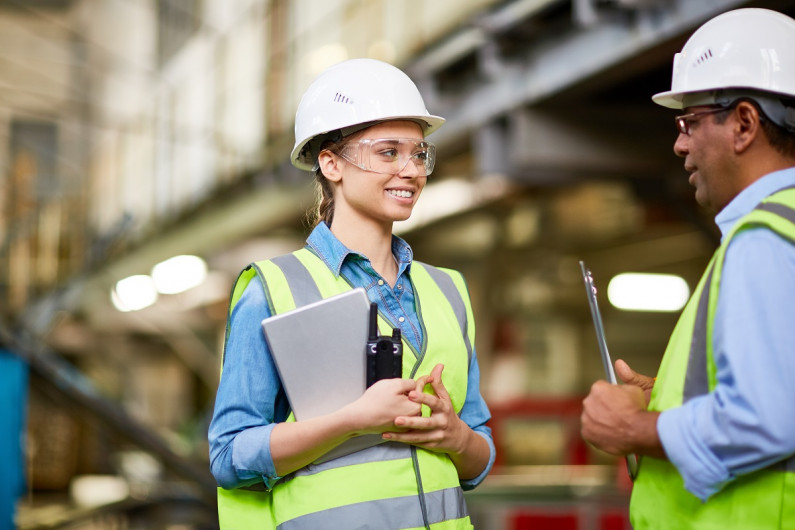 Female engineer talks to manager