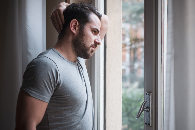 A man looks out an open door