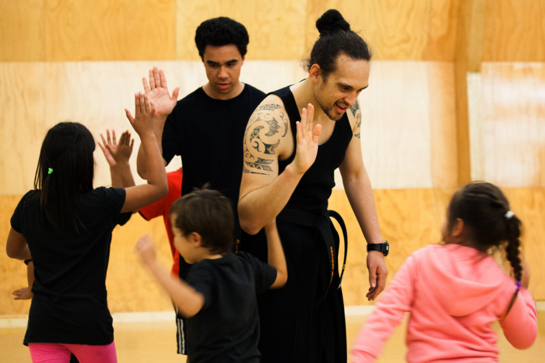 Kaiwhakaako Māori giving high fives to learners