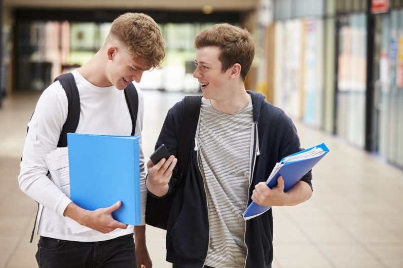 Two young men chatting as they walk together