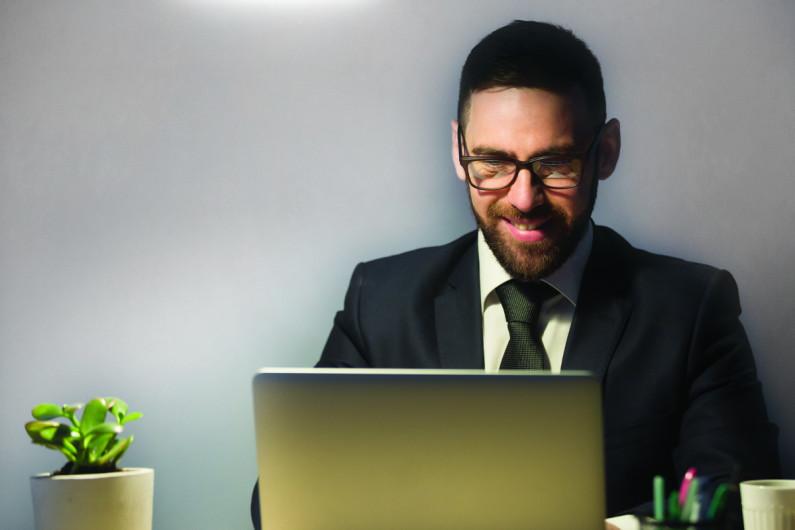 Young man having an online interview on laptop