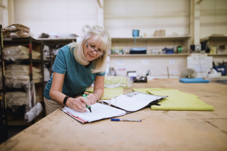 A mature worker taking inventory in a warehouse