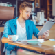 Man looking at tablet in cafe