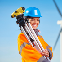 Surveyor in safety gear holds equipment