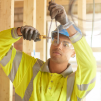 Electrician cuts wires hanging down from ceiling