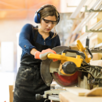 Carpenter uses skill saw to cut wood