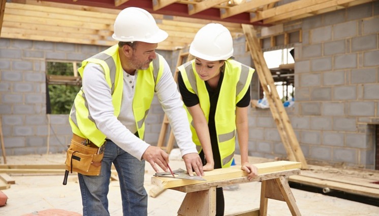 Construction worker with his apprentice