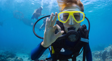 a diver signals OK under water